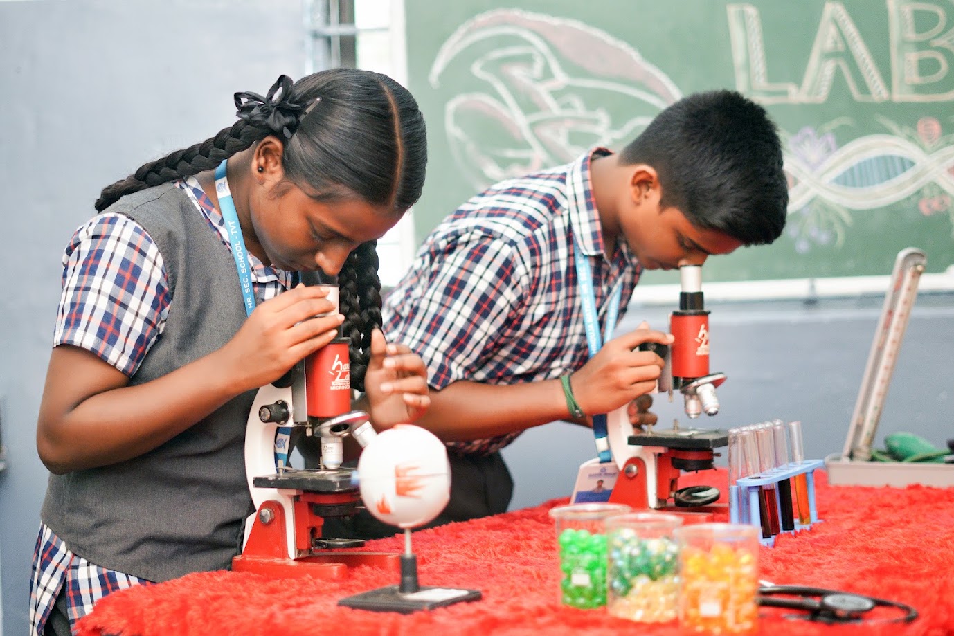Student looking through a binocular microscope